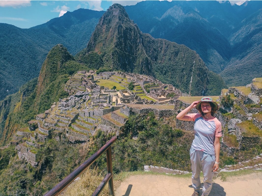 Girl with a hat standing at the view point in Machu Pichu, Peru