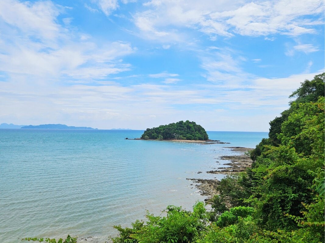 Small island in the distance on the sea, rocky shore and jungle, Koh Lanta