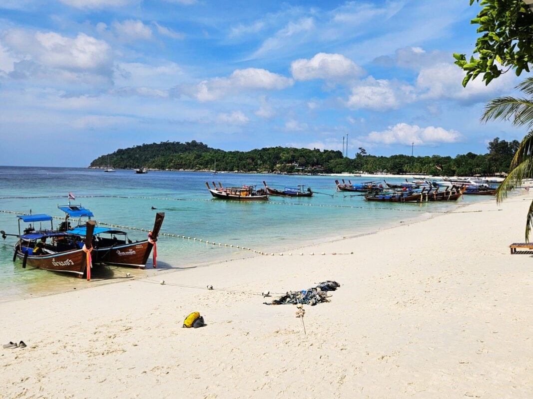 Boats by the beach on Koh Lipe, clear, blue water, white sand