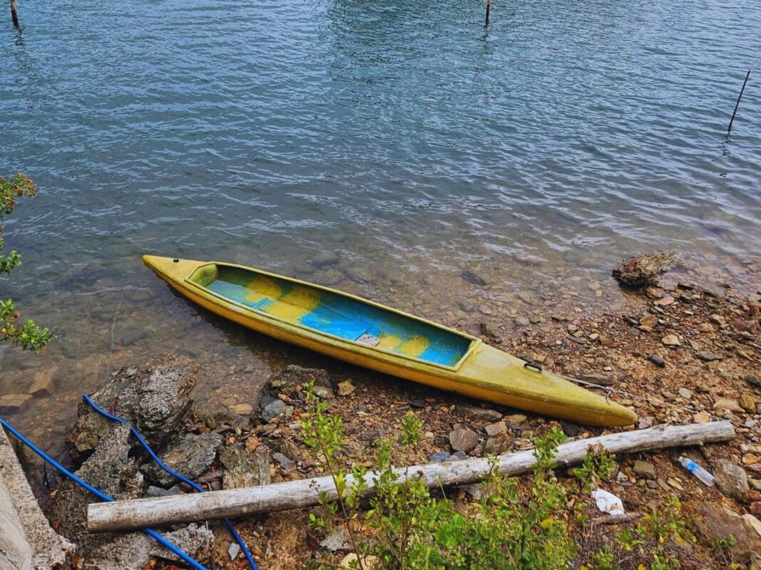 Kayak on the rocky shore near the Siri Bridge on Koh Lanta