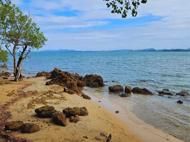 Rocky beach, tree and sea, islands in the distance, Koh Lanta