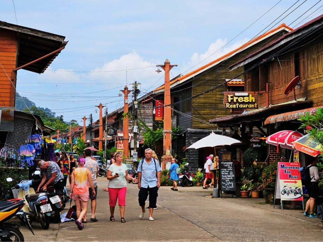 Traditional wooden houses, restauants and tourists at Walking street on Koh Lanta Old Town