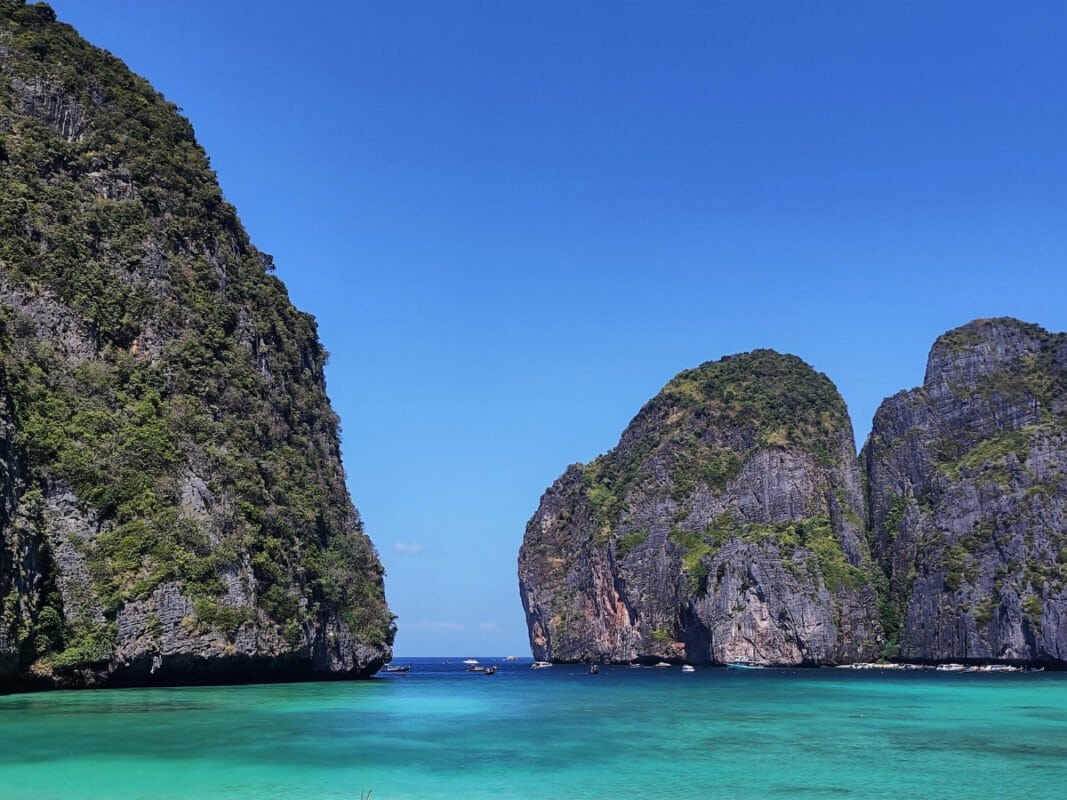 View of the Koh Phi Phi Leh Maya Bay, clear, blue sea and huge limestone cliffs in the distance