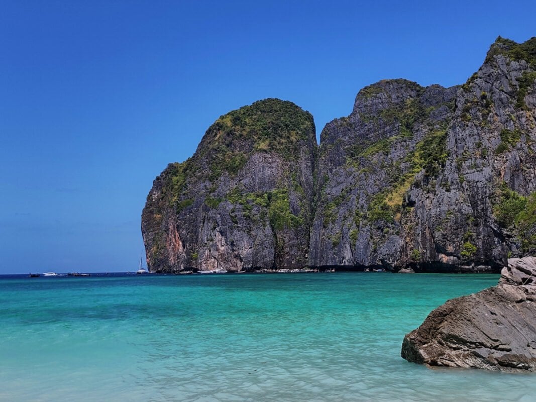 View of the Koh Phi Phi Leh Maya Bay, clear, blue sea and huge limestone cliffs in the distance