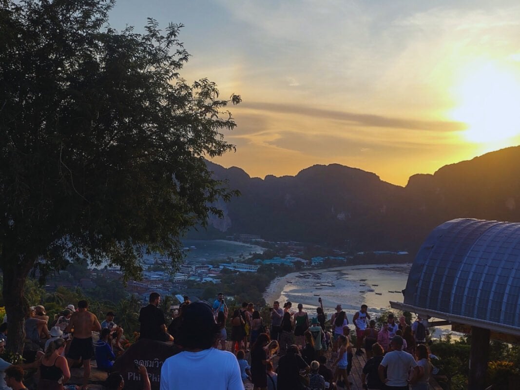 Koh Phi Phi crowds at the viewpoint, buildings and mountains in the distance