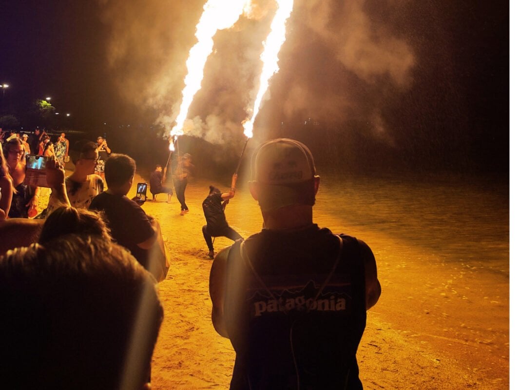 Fire show at Koh Phi Phi beach, tourist watching and recording a show