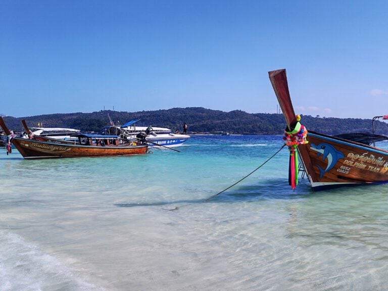 Koh Phi Phi long tailed boats by the beach, mountains in the distance