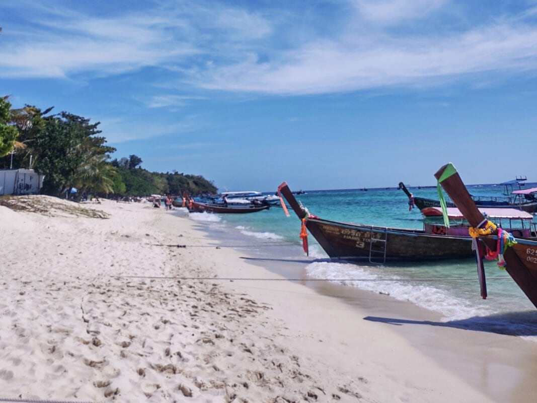 Koh Phi Phi sandy Long beach with longtail boats by he shore