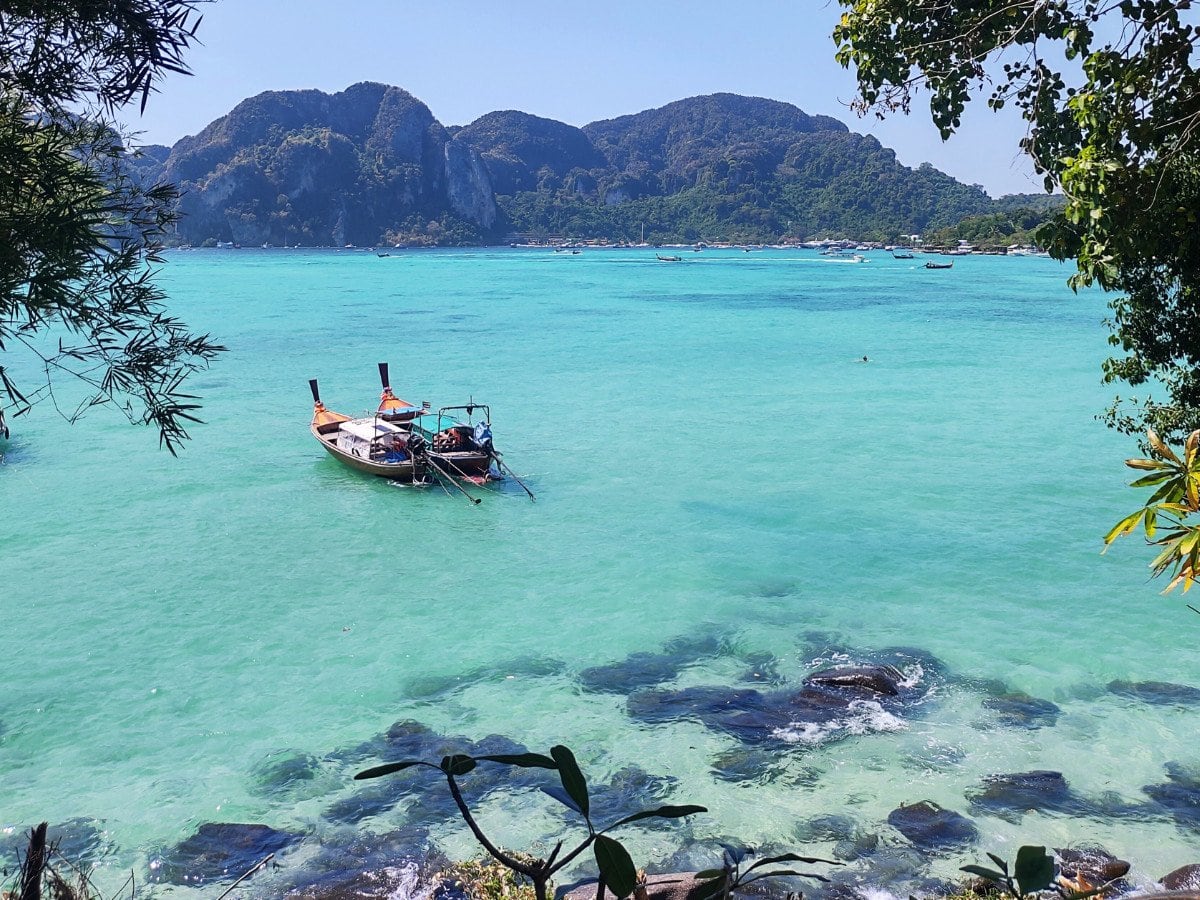 Koh Phi Phi clear blue sea, boats and mountains in the distance