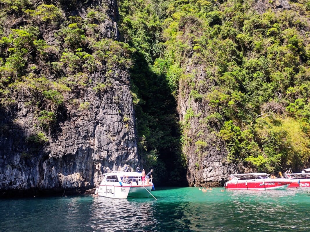 Boats and people swimming at the snorkeling spot near Koh Phi Phi