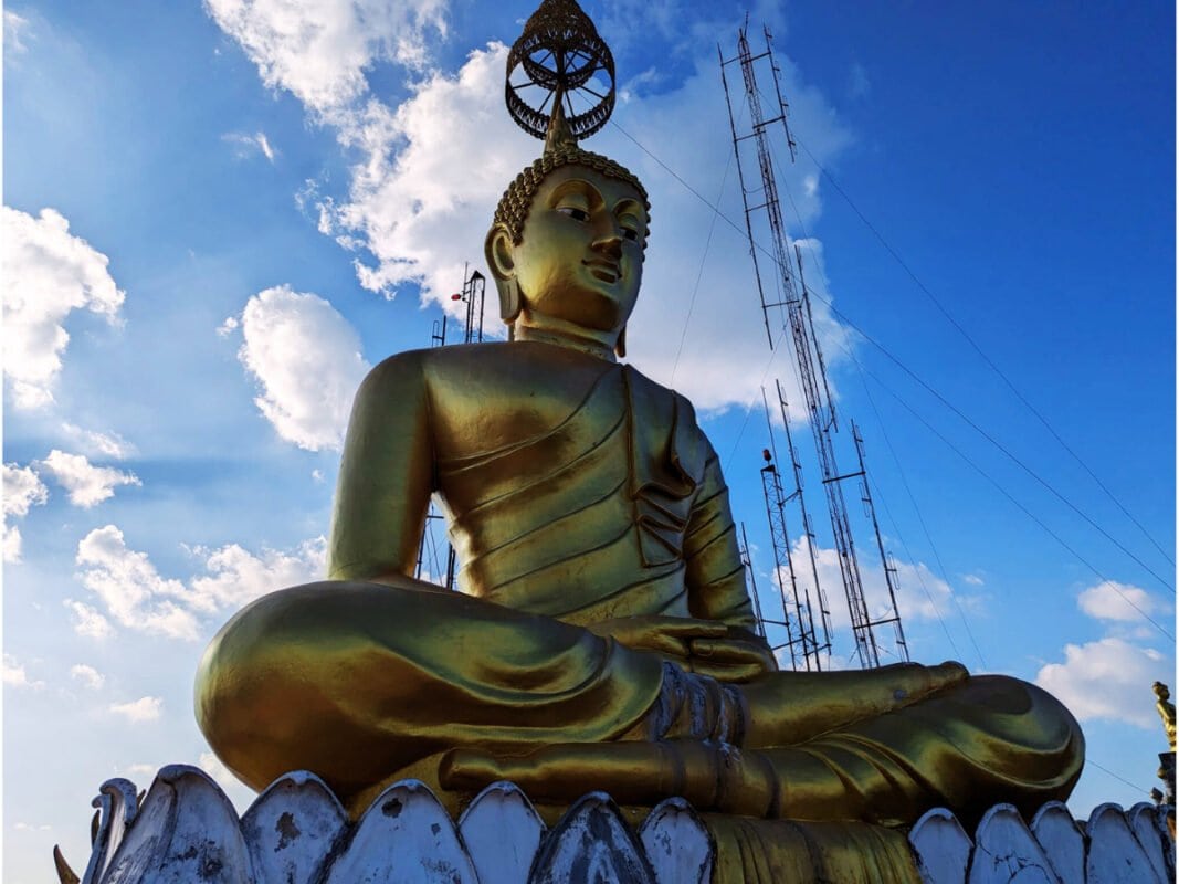 Golden buddha sitting statue at the Tiger Cave temple near Krabi town