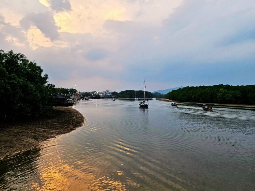 Krabi river sunset, boats and mangroves