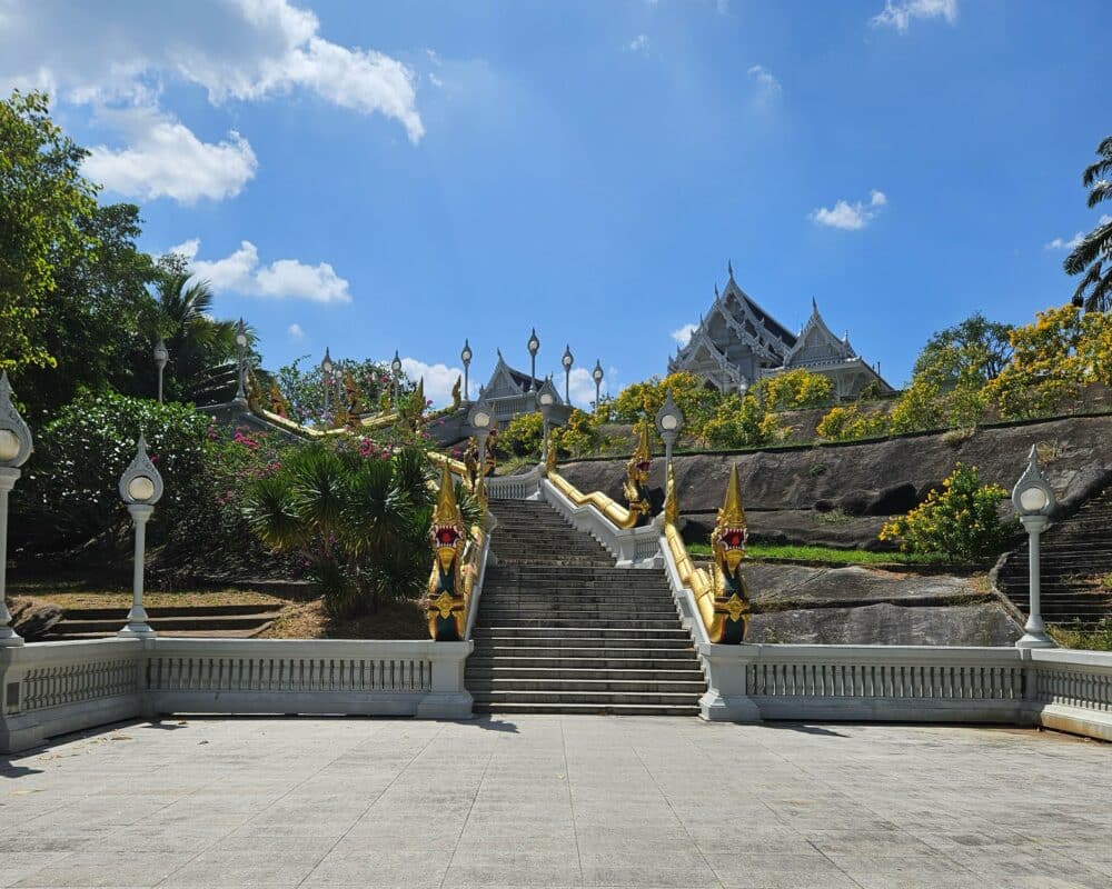 Bottom of the stairs with golden ornaments, leading to The White Temple - Wat Kaew in Krabi Town