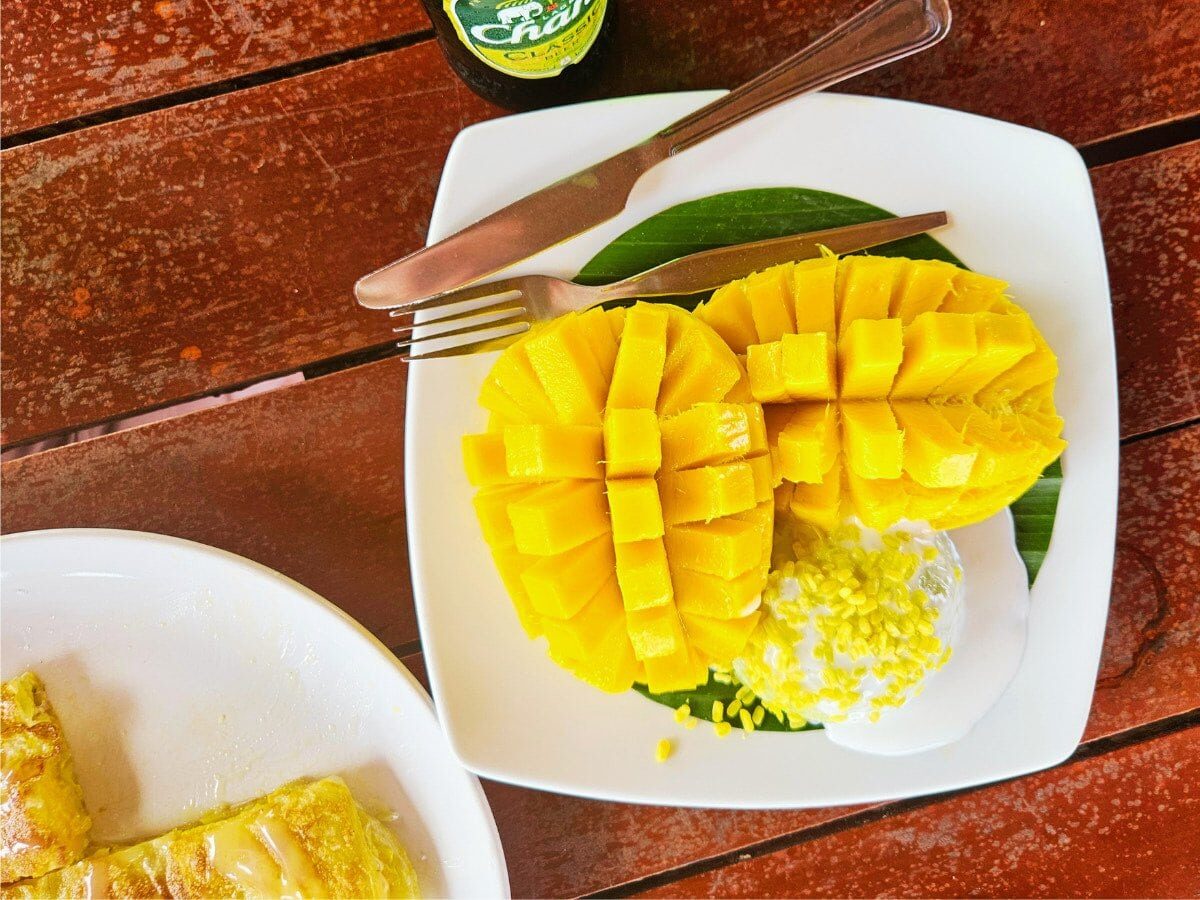 thai mango sticky rice dessert served with coconut cream at a restaurant on Koh Lipe Thailand