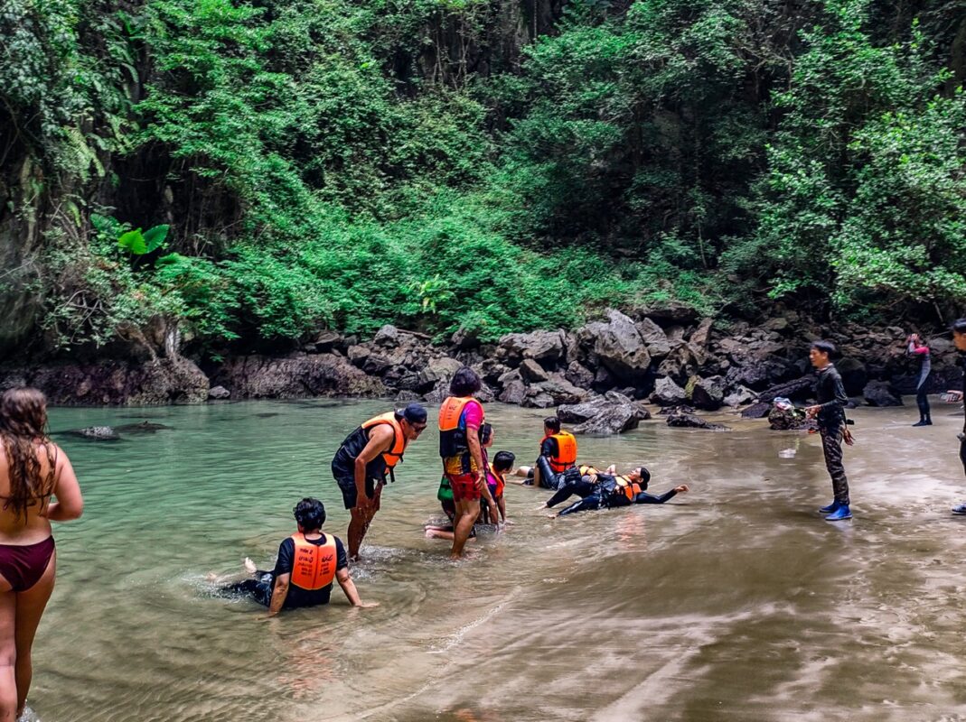 visitors relaxing inside emerald lagoon morakot cave koh mook