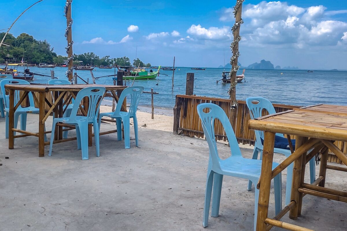 Seafront café with longtail boats on Koh Mook island Thailand
