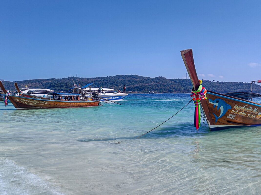 traditional longtail boats on koh phi phi beach used for island hopping in southern thailand