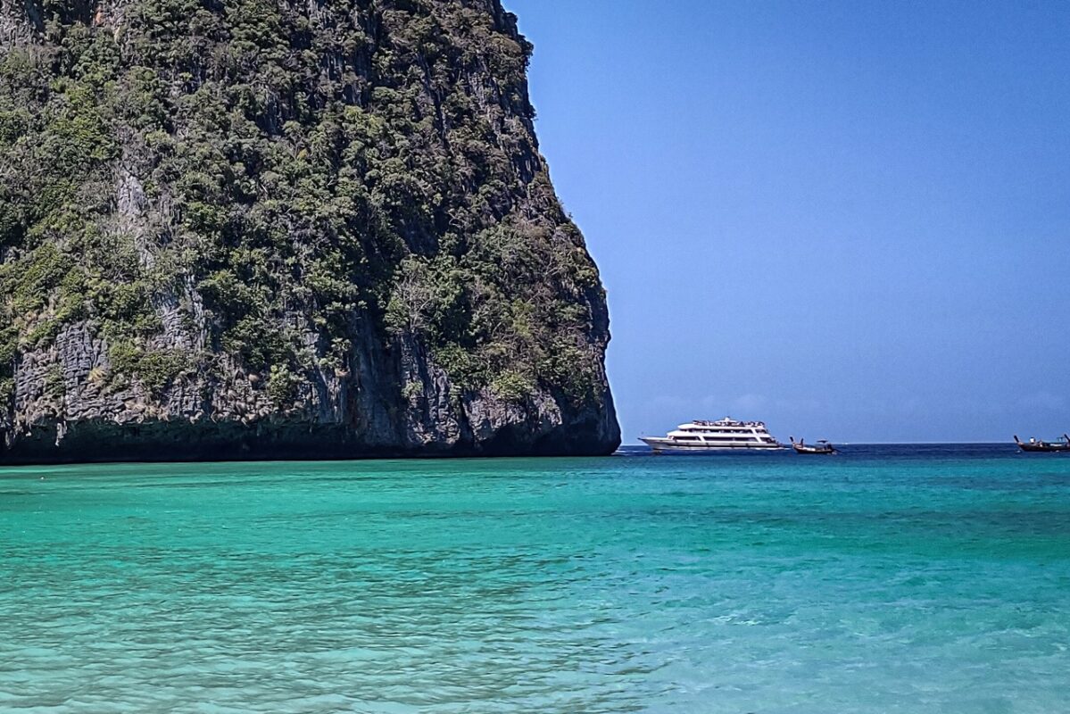 Longtail boats in Maya Bay Koh Phi Phi with turquoise water and limestone cliffs