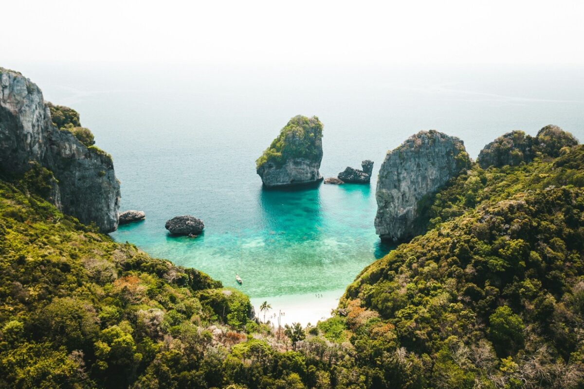 Nui Beach Koh Phi Phi turquoise water limestone cliffs hidden cove.