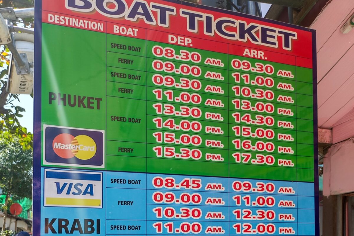 Ferry and speedboat departure schedule board showing routes between Phuket and Krabi in Southern Thailand.