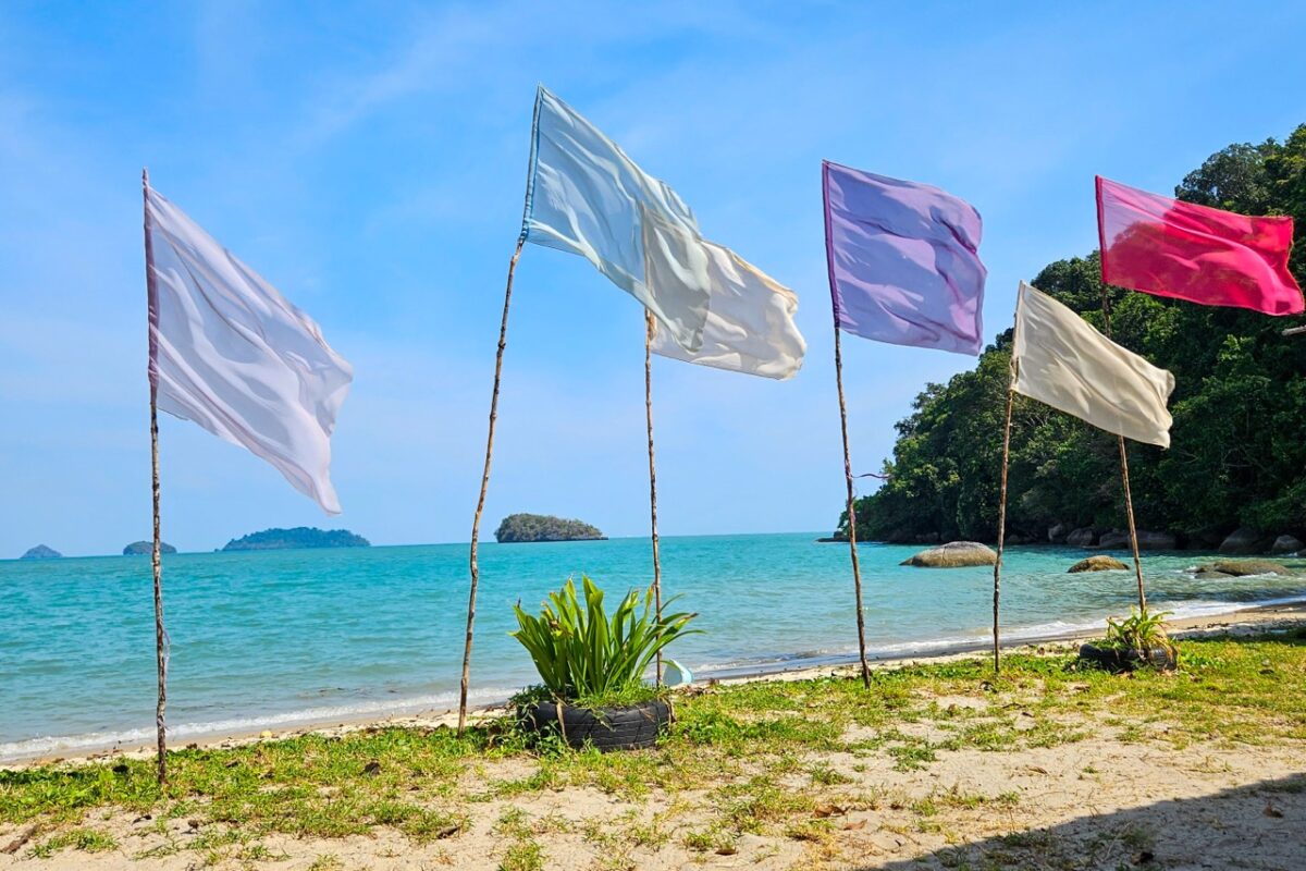 Colorful beach flags on Pulau Tuba island Langkawi