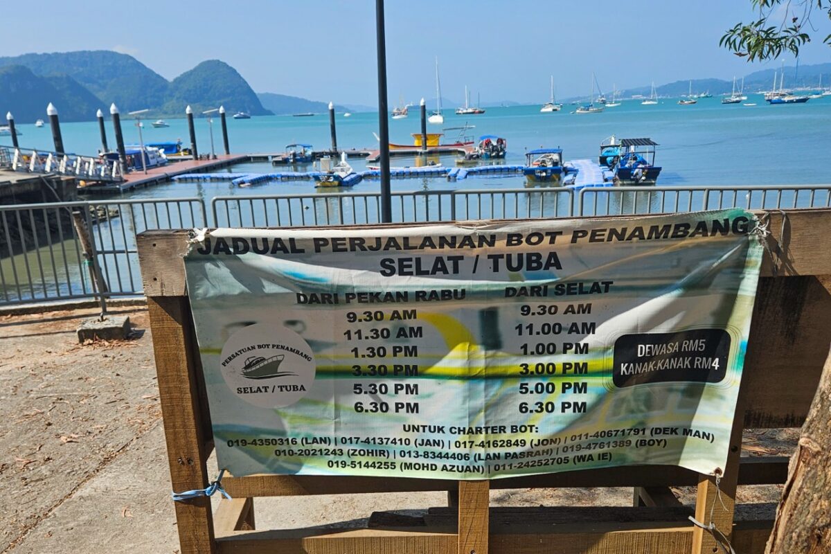 Boat schedule sign for Selat and Pulau Tuba from Kuah jetty