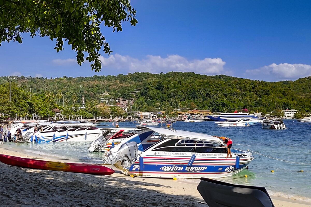 speedboats parked on koh phi phi beach used for island transfers in southern thailand