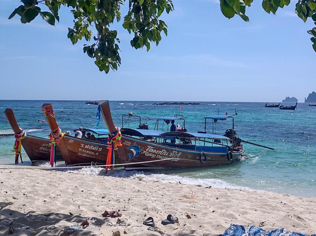 traditional thai longtail boats on koh phi phi beach in southern thailand