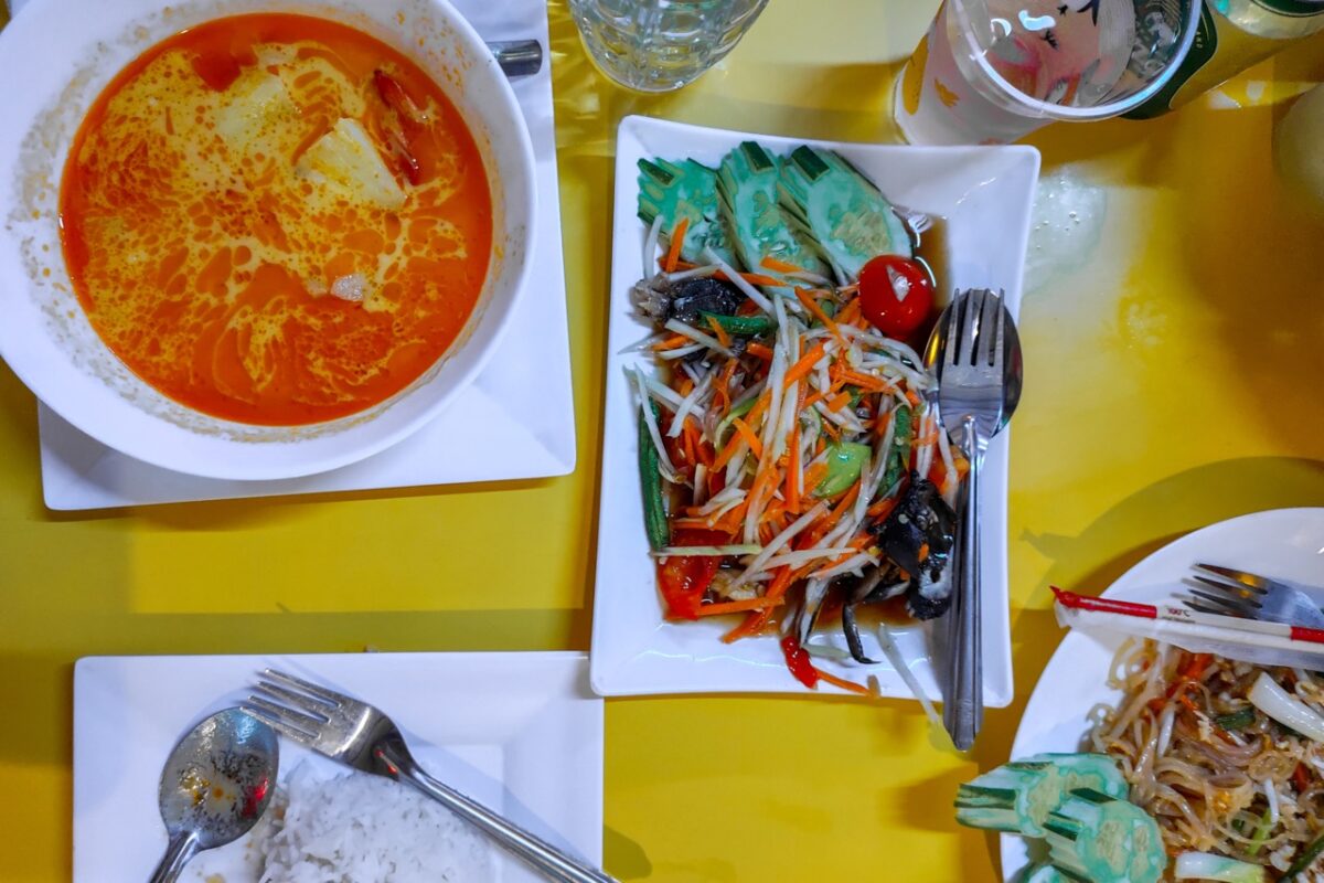 Thai food in Koh Lipe including papaya salad and curry served at a local restaurant on Walking Street