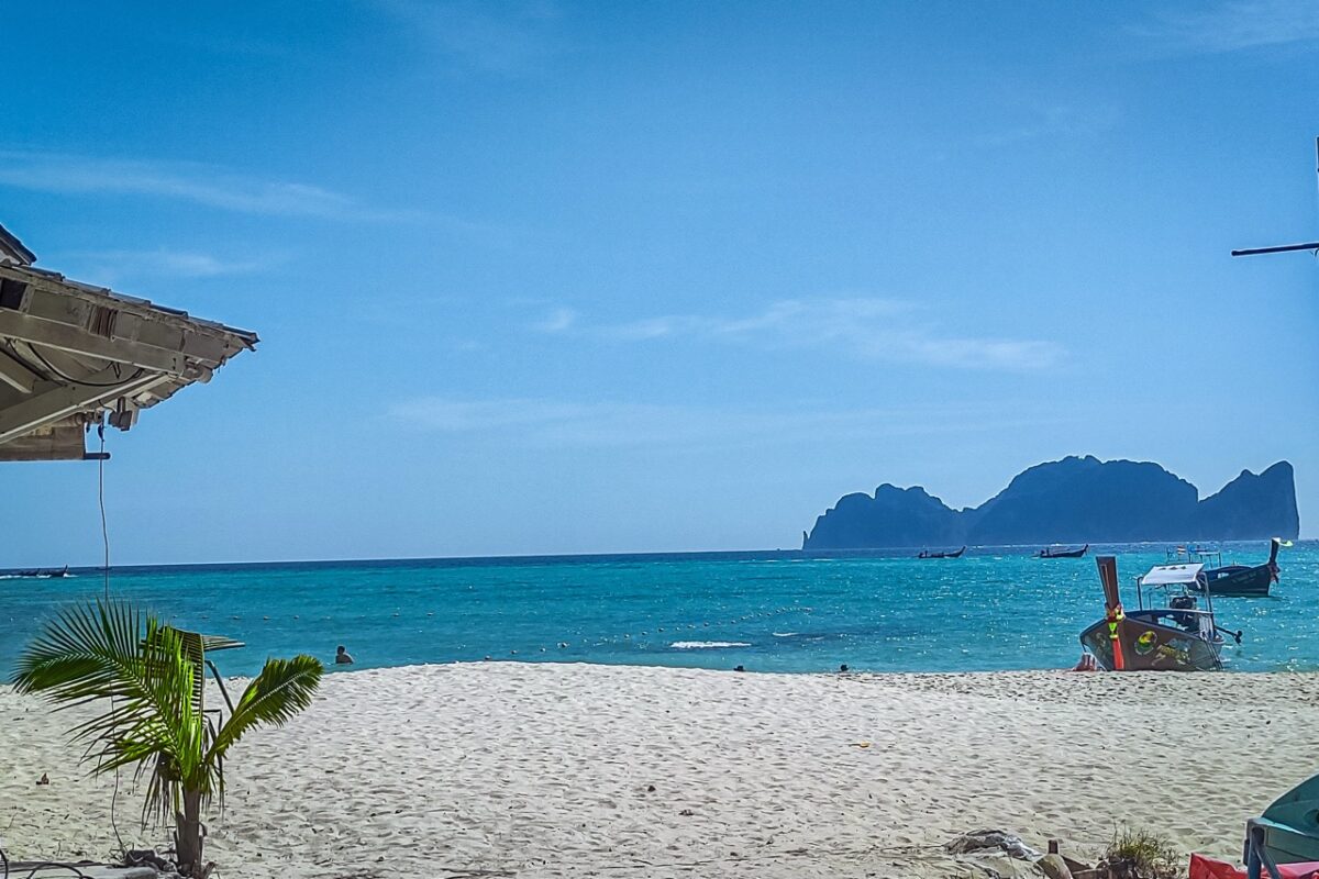 Beach view in Koh Phi Phi with turquoise water and longtail boats