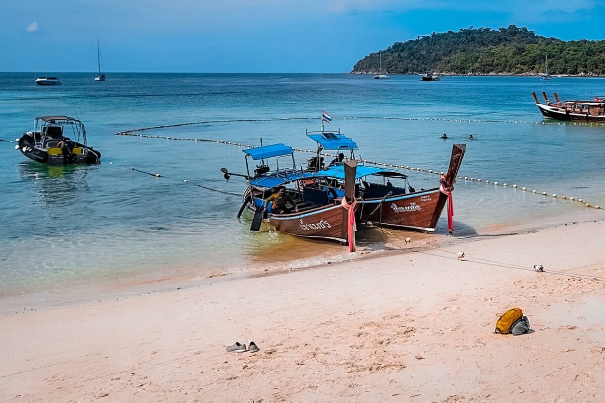 Longtail boats on Pattaya Beach Koh Lipe Thailand with clear water