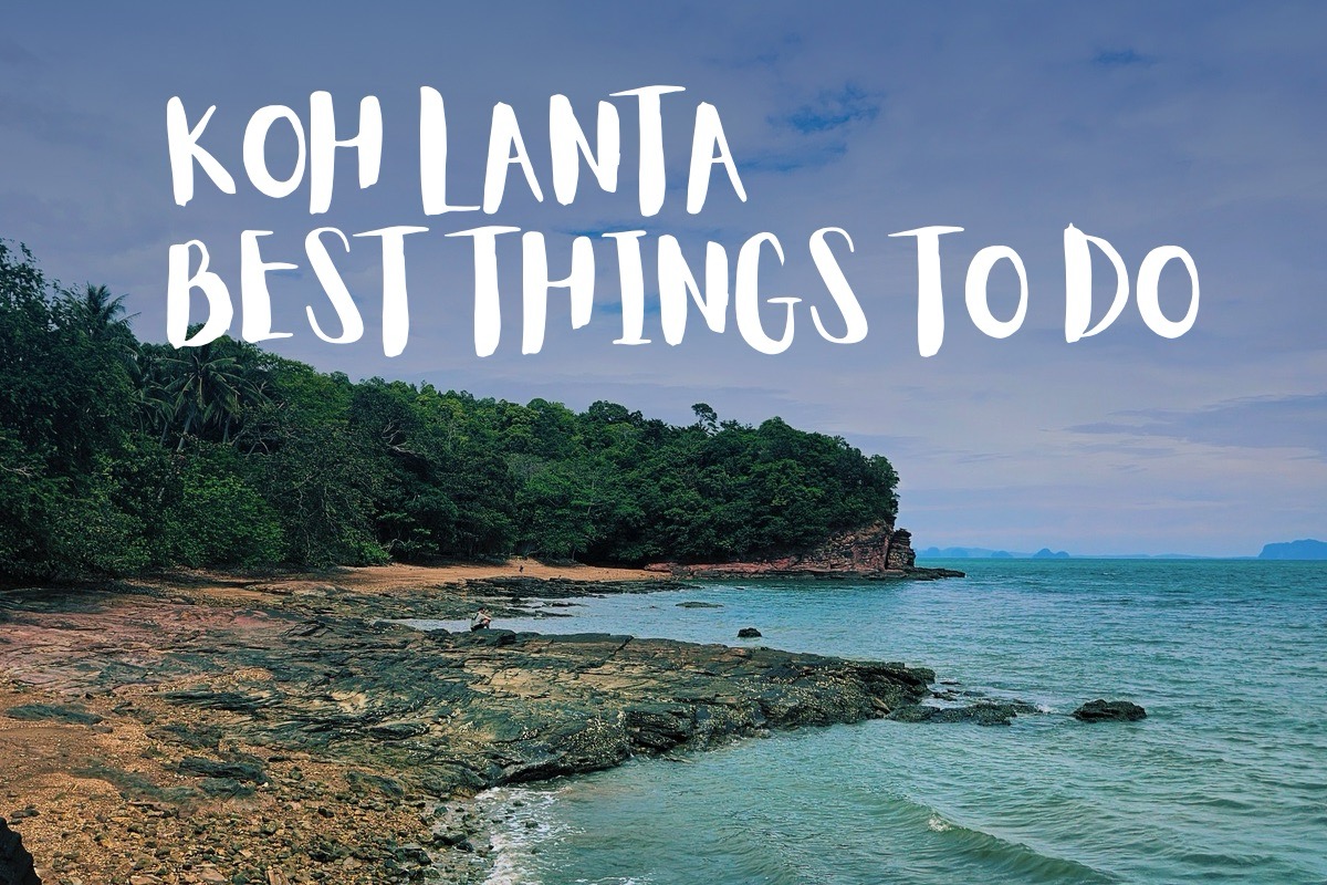 View of the rocky shore and sign Best Things to Do on Koh Lanta